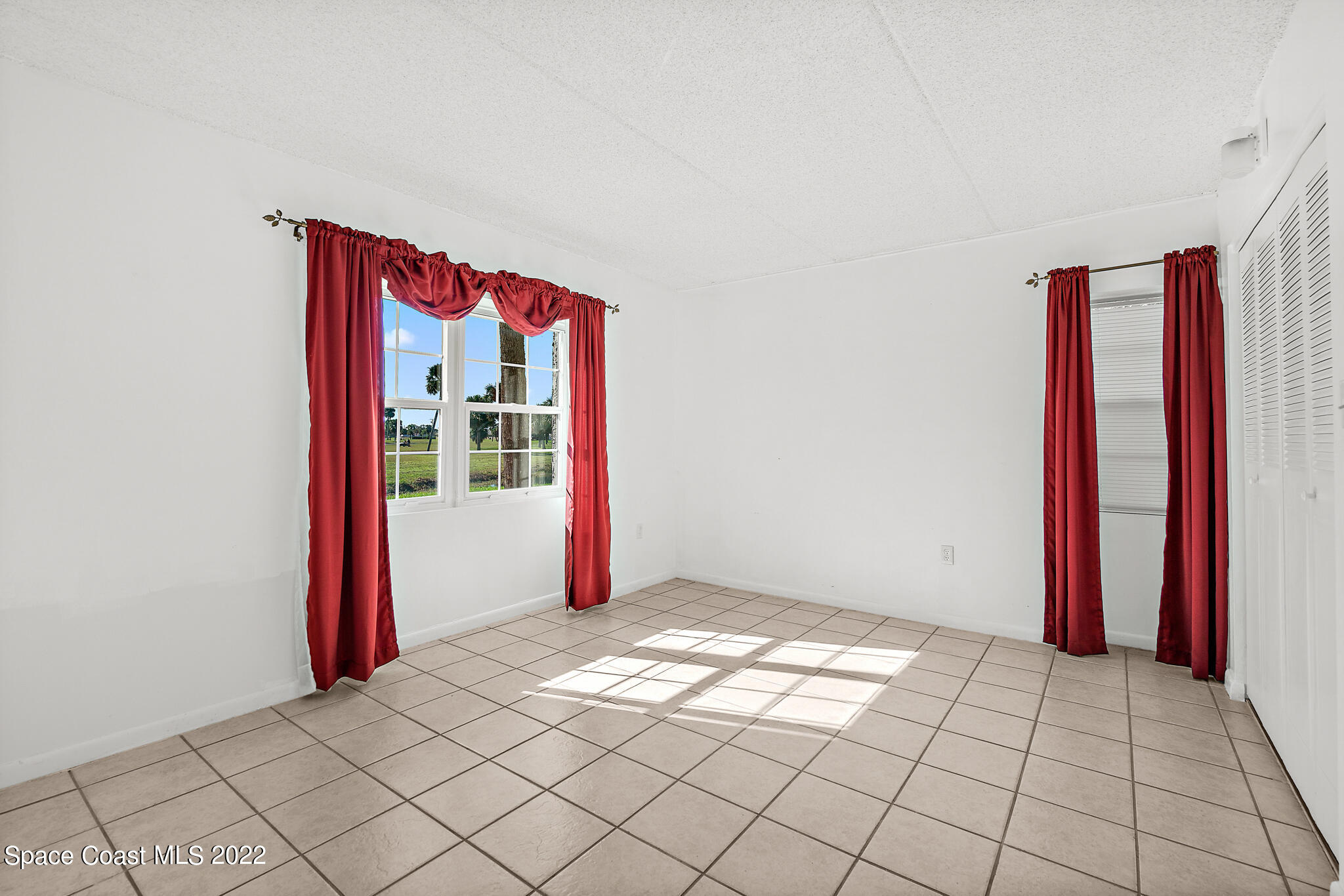 2727 North Wickham Road, Unit 1018 Melbourne, FL 32935 - Photo 11 of 21 Guest Bedroom