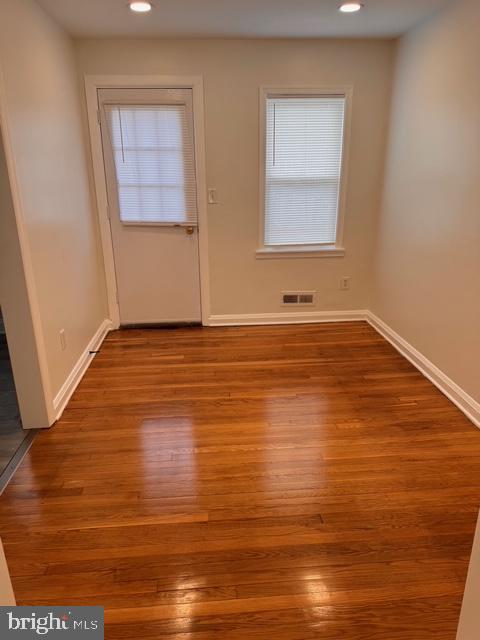 1090 Cameron Road Baltimore, MD 21212 - Photo 7 of 19 a view of an empty room with wooden floor and a window