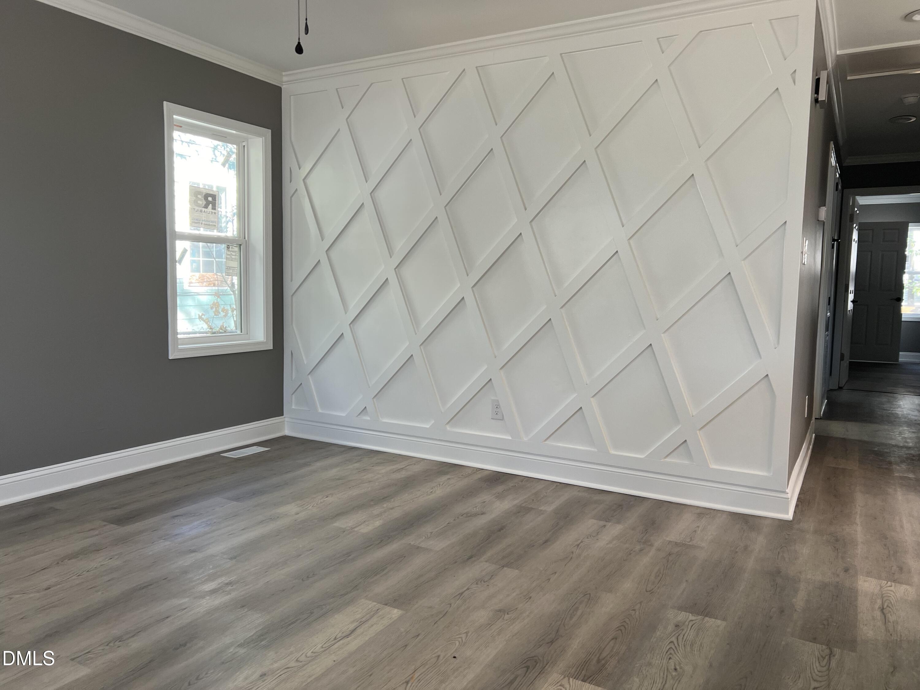 102 St Augustine Raleigh, NC 27610 - Photo 4 of 13 an empty room with wooden floor and windows