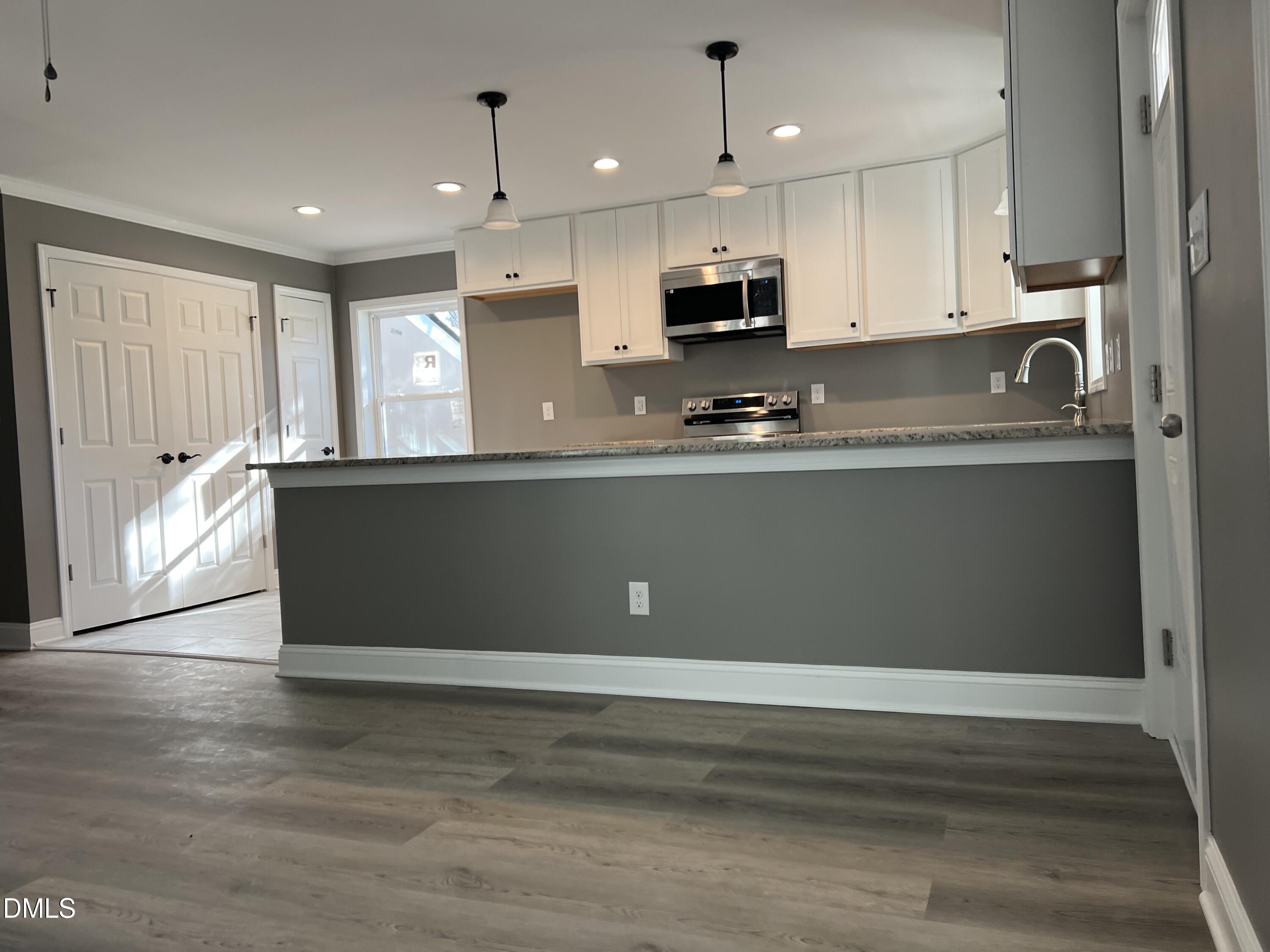 102 St Augustine Raleigh, NC 27610 - Photo 6 of 13 a kitchen with stainless steel appliances granite countertop a refrigerator a sink and a stove