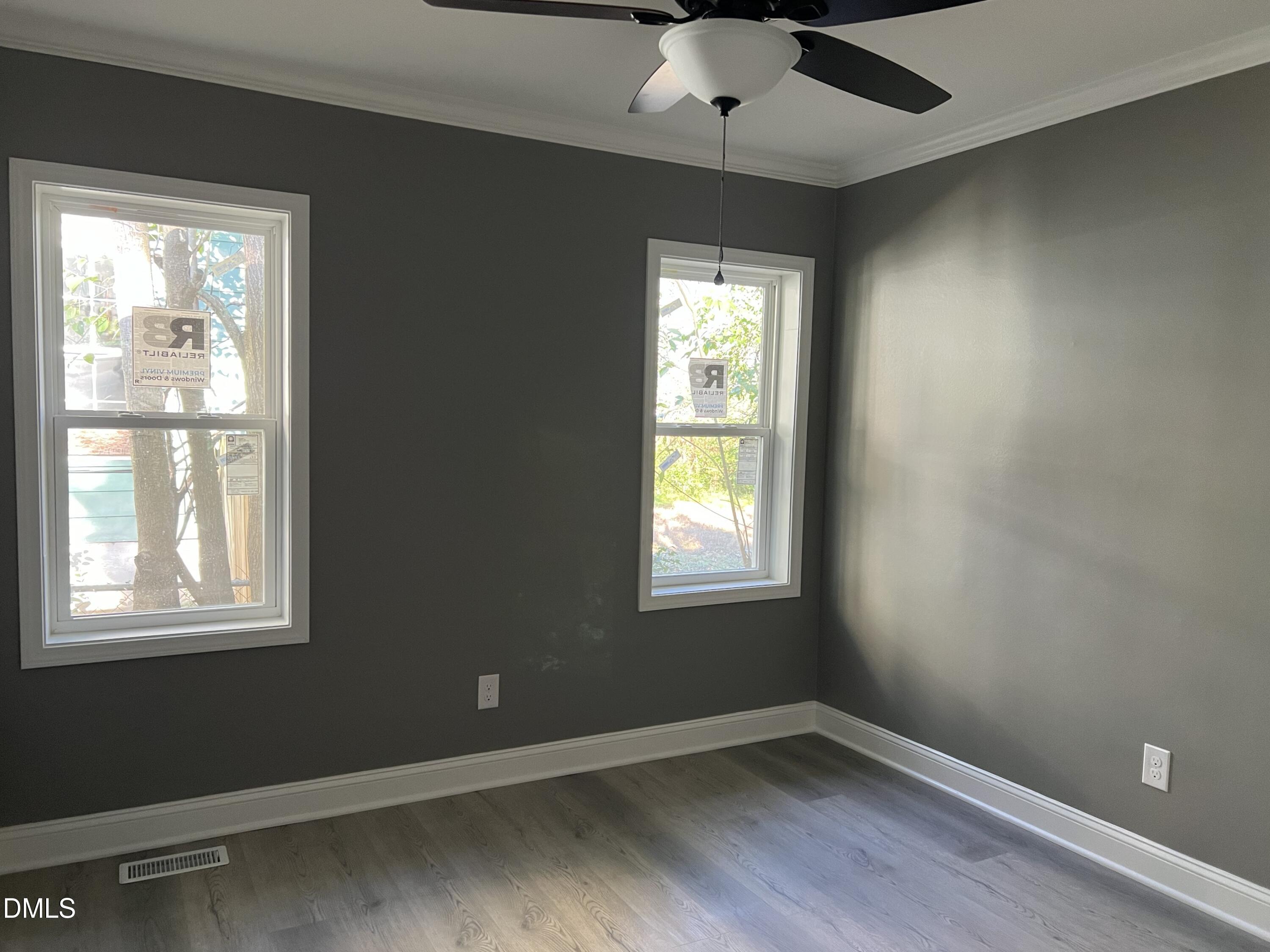 102 St Augustine Raleigh, NC 27610 - Photo 10 of 13 an empty room with a window and wooden floor