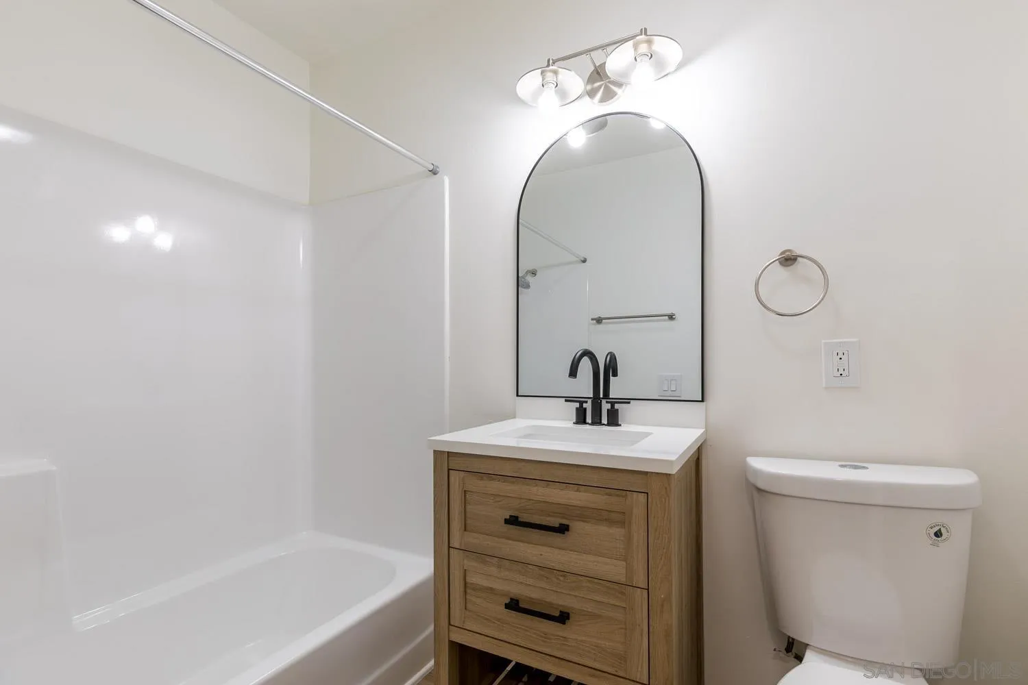 9249 Birch Street Spring Valley, CA 91977 - Photo 11 of 24 a bathroom with a sink a toilet and a mirror