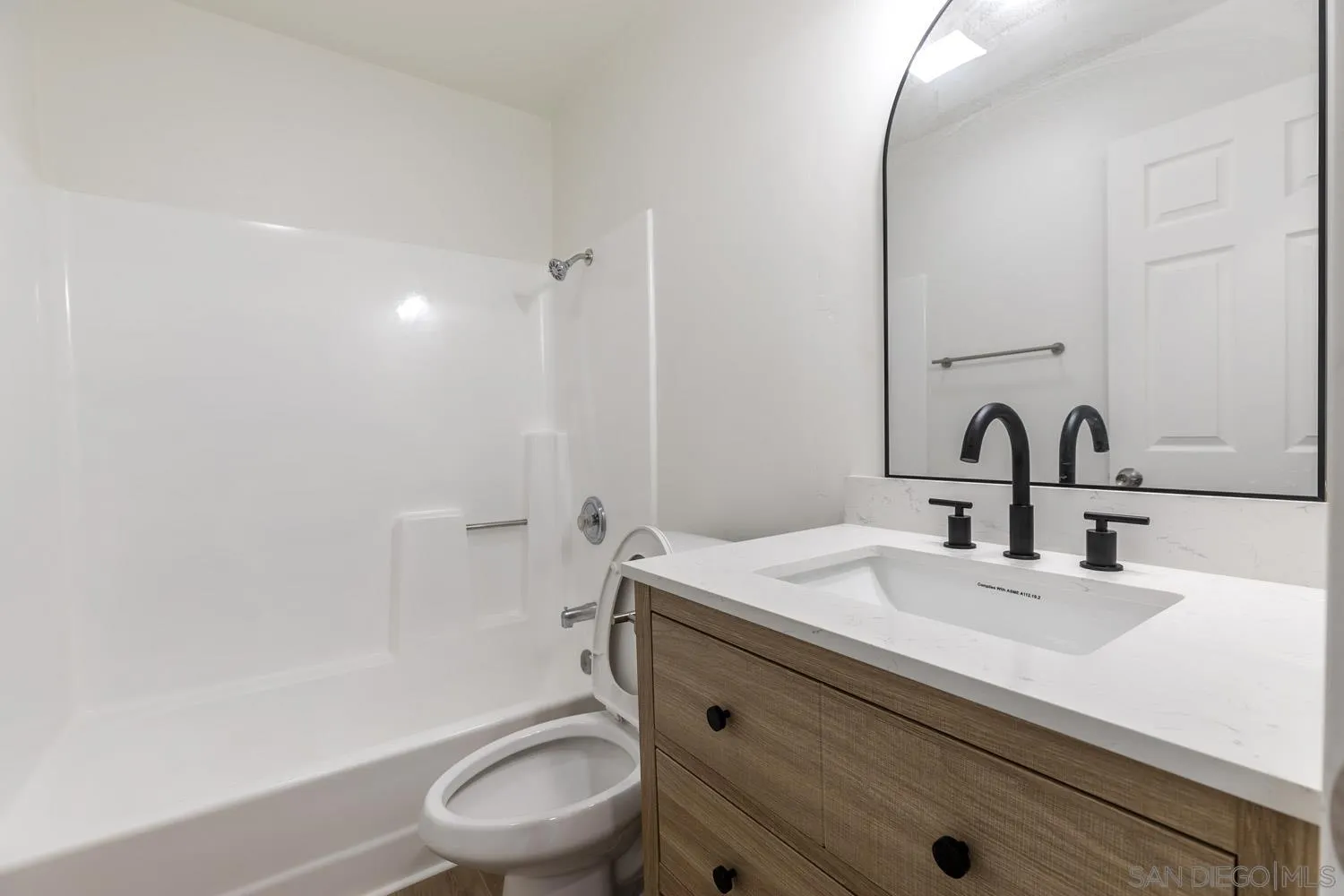 9249 Birch Street Spring Valley, CA 91977 - Photo 15 of 24 a bathroom with a sink toilet and a mirror