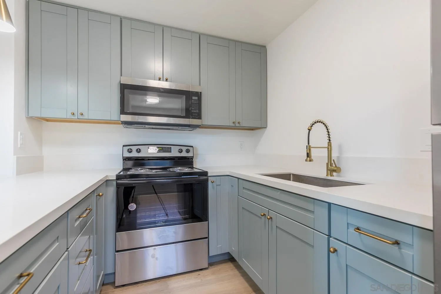 9249 Birch Street Spring Valley, CA 91977 - Photo 17 of 24 a kitchen with sink a stove and microwave