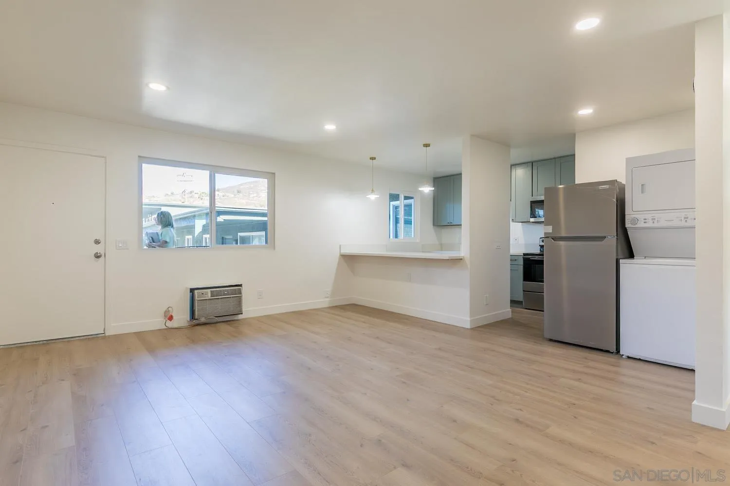 9249 Birch Street Spring Valley, CA 91977 - Photo 8 of 24 a view of an empty room with a window and wooden floor