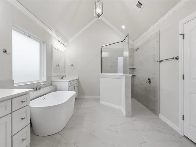 a bathroom with a granite countertop sink a toilet a mirror and shower
