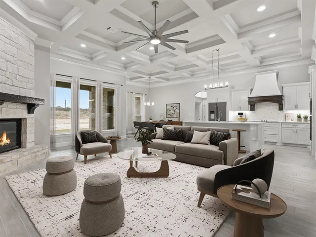a living room with furniture kitchen view and a fireplace
