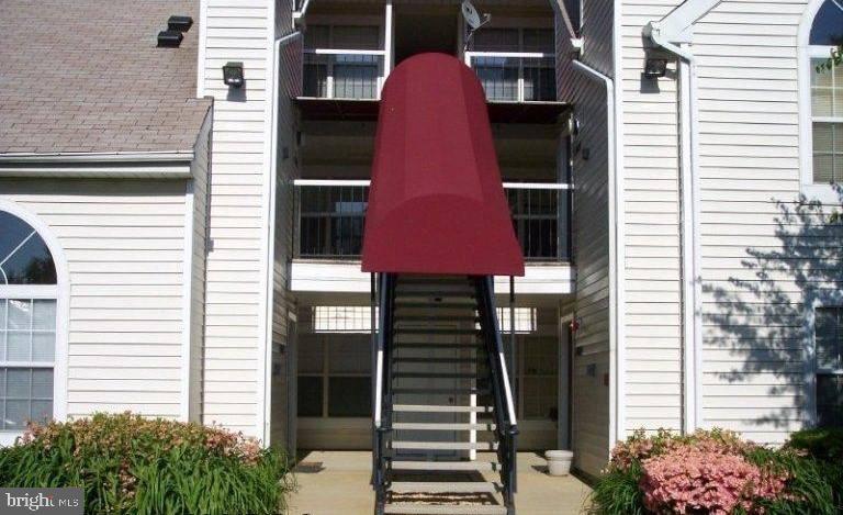 Charming entrance with unique awning.
