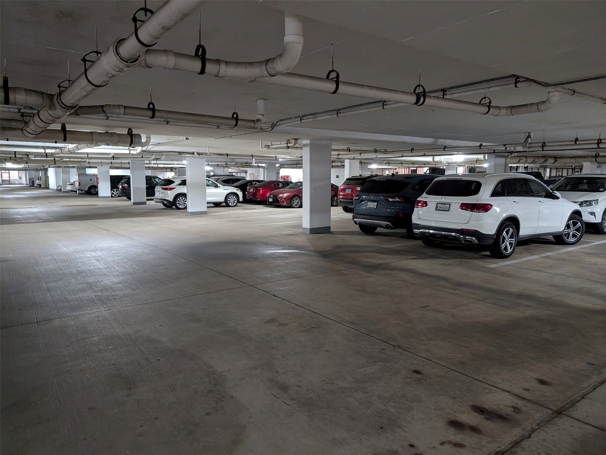 2400 McCue Road, Unit 136 Houston, TX 77056 - Photo 19 of 25 Spacious underground parking garage with ample lighting and multiple parking spaces.