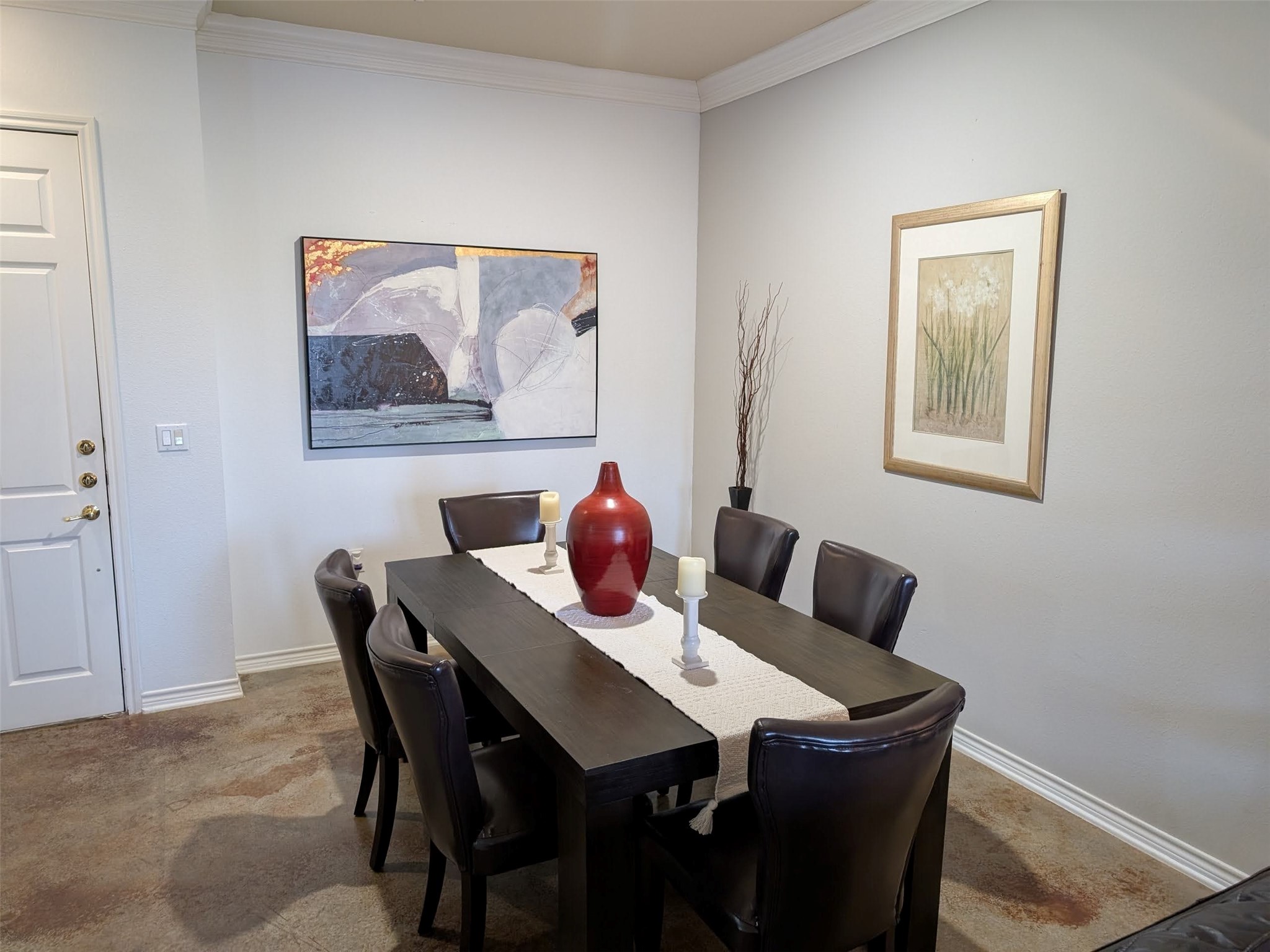2400 McCue Road, Unit 136 Houston, TX 77056 - Photo 4 of 25 This dining area features a modern table with six leather chairs, complemented by contemporary artwork on neutral walls. A decorative centerpiece and framed art add elegance to the space.
