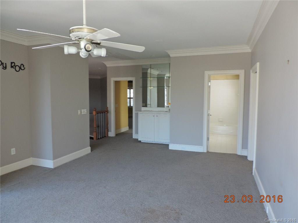 19213 Captains Watch Road Cornelius, NC 28031 - Photo 14 of 23 a view of a livingroom with a chandelier fan and windows
