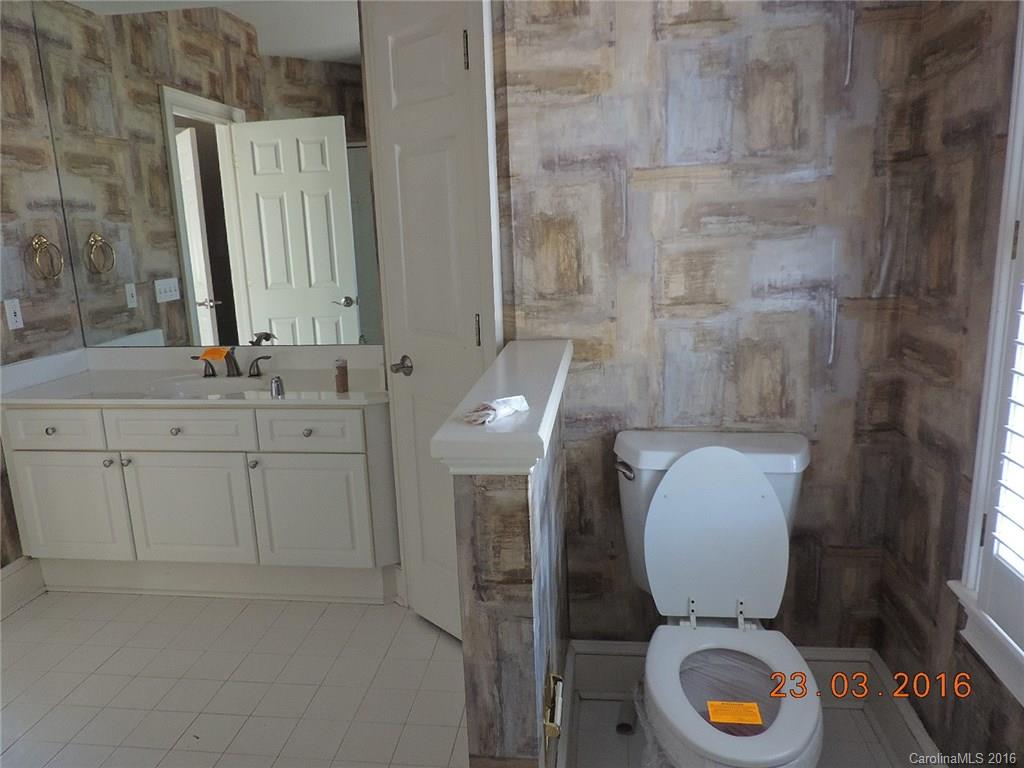 19213 Captains Watch Road Cornelius, NC 28031 - Photo 18 of 23 a bathroom with a toilet a sink and mirror