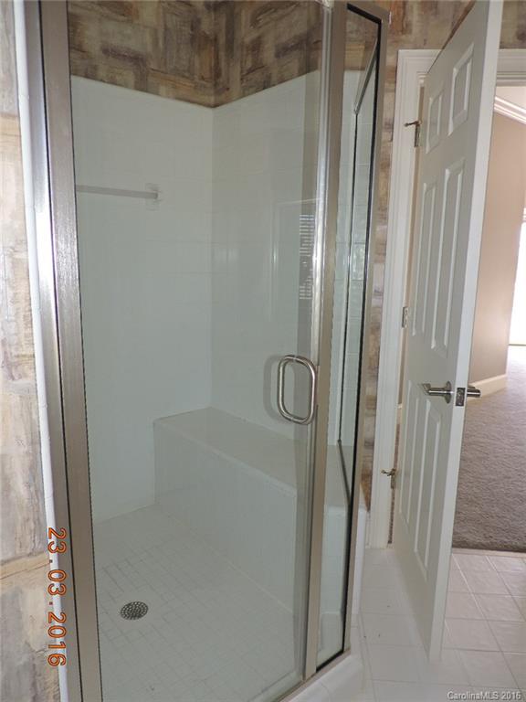 19213 Captains Watch Road Cornelius, NC 28031 - Photo 19 of 23 a bathroom with a glass shower door