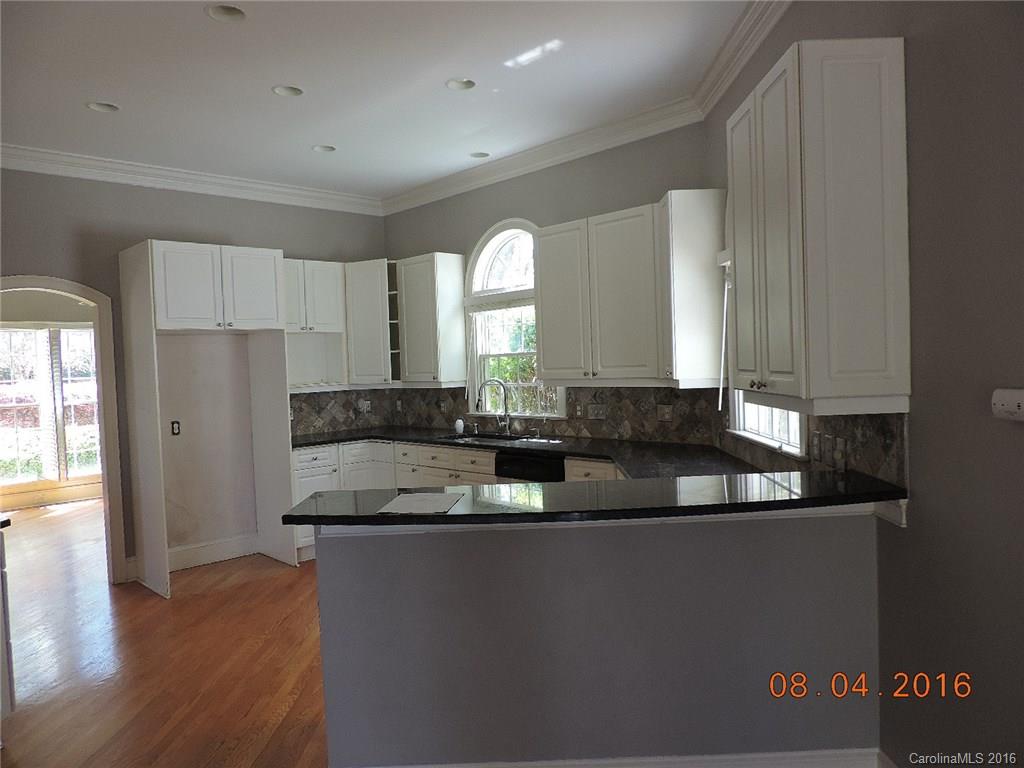 19213 Captains Watch Road Cornelius, NC 28031 - Photo 5 of 23 a large kitchen with granite countertop a stove a sink and a granite counter top