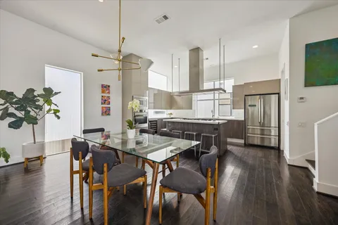 a kitchen with stainless steel appliances kitchen island granite countertop a stove a sink and a refrigerator