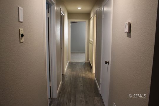 401 Ashton Street Ridgecrest, CA 93555 - Photo 17 of 36 a view of a hallway with wooden floor