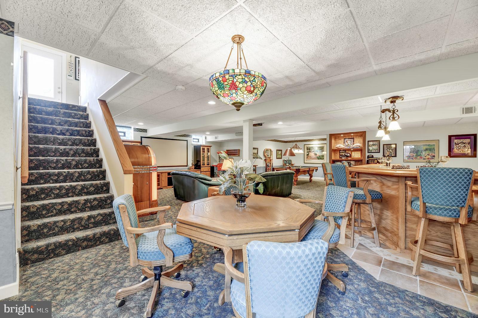 2316 Wilson Road White Hall, MD 21161 - Photo 29 of 37 a dining room with wooden floor a chandelier a wooden table and chairs