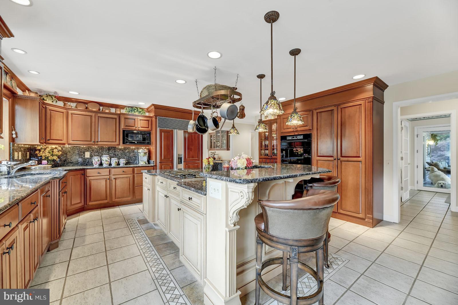 2316 Wilson Road White Hall, MD 21161 - Photo 4 of 37 a kitchen with stainless steel appliances granite countertop a refrigerator a sink a stove and a wooden cabinets