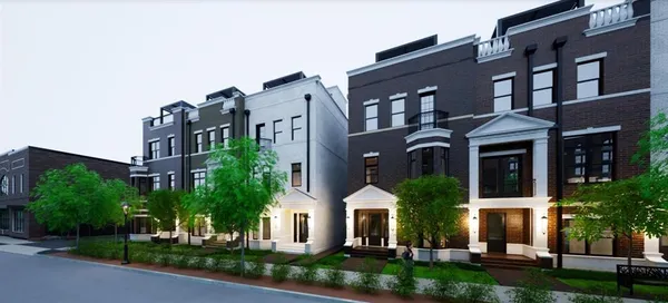 a front view of a residential apartment building with a yard and plants