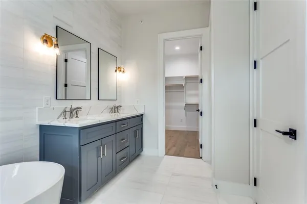 a bathroom with a bathtub shower sink and mirror
