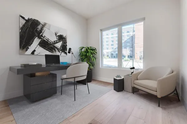 a living room with furniture a bed and a window