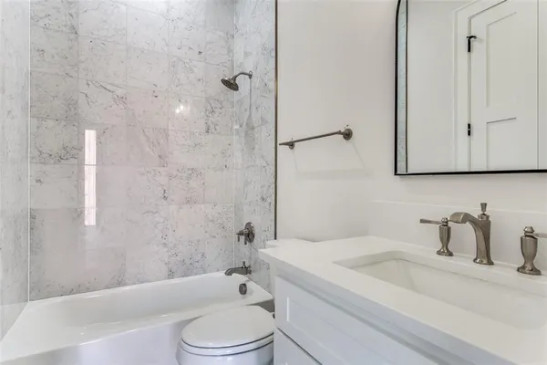 a bathroom with a sink a toilet and a bathtub