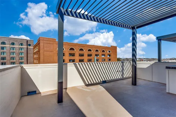 a balcony with furniture and wooden floor