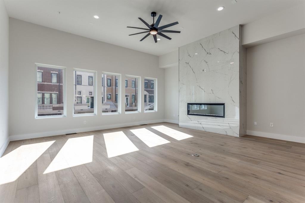 250 East Dallas Road, Unit 112 Grapevine, TX 76051 - Photo 4 of 33 a view of an empty room with window and wooden floor
