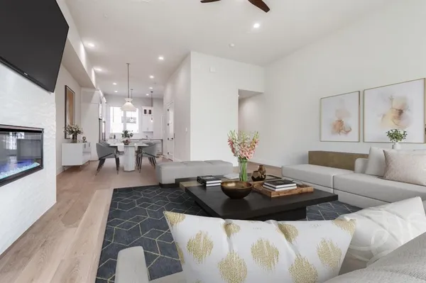 a living room with furniture and a wooden floor
