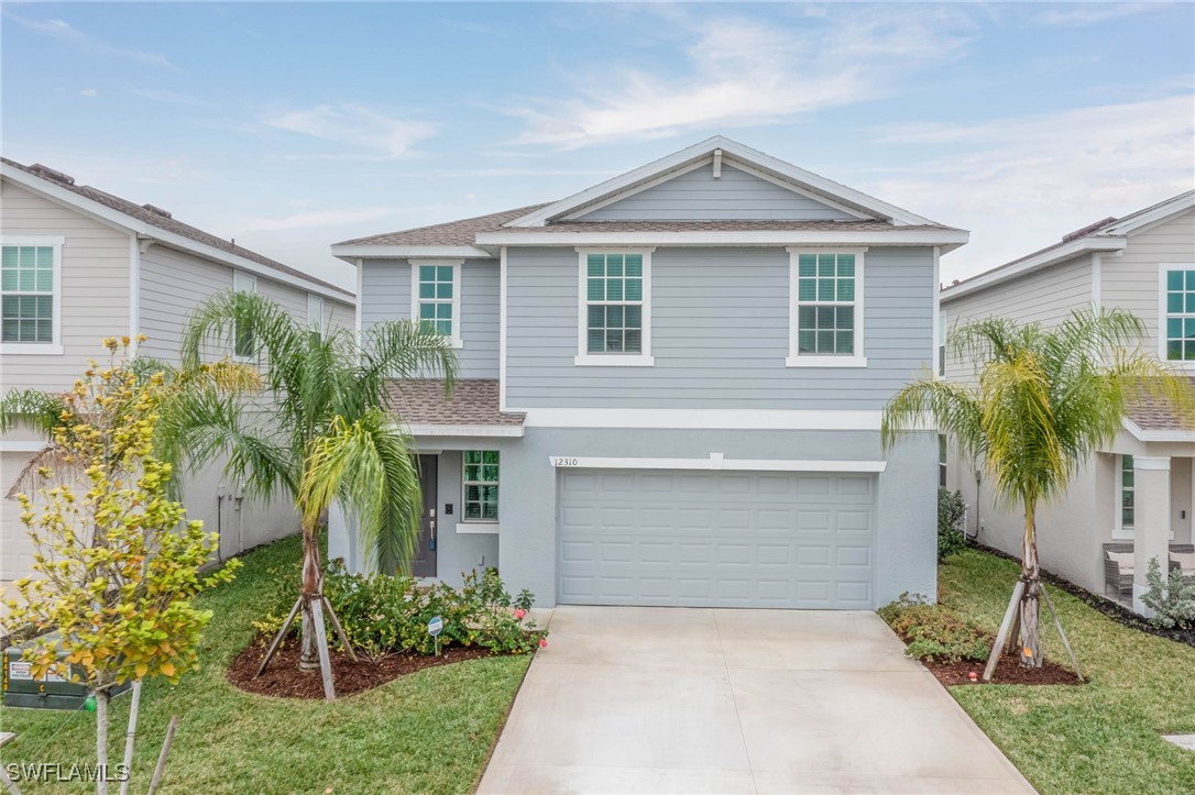 12310 Dakota Ridge Place Lehigh Acres, FL 33974 - Photo 1 of 34 front view of a house with a yard