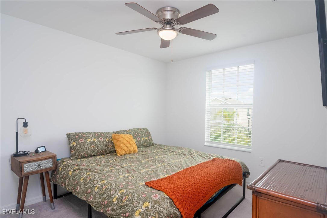 12310 Dakota Ridge Place Lehigh Acres, FL 33974 - Photo 19 of 34 a bedroom with a bed and window