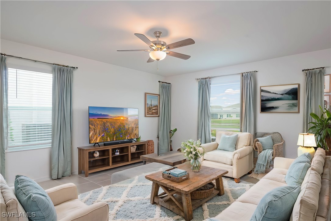 12310 Dakota Ridge Place Lehigh Acres, FL 33974 - Photo 2 of 34 a living room with furniture and a flat screen tv
