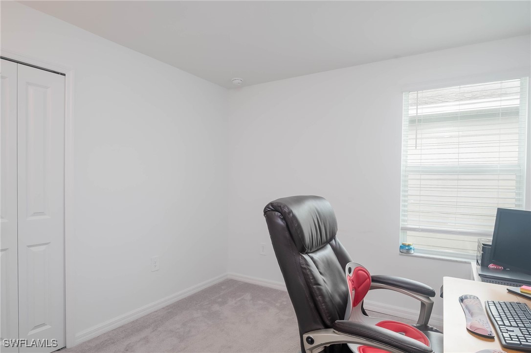12310 Dakota Ridge Place Lehigh Acres, FL 33974 - Photo 28 of 34 a view of workspace with lounge chair