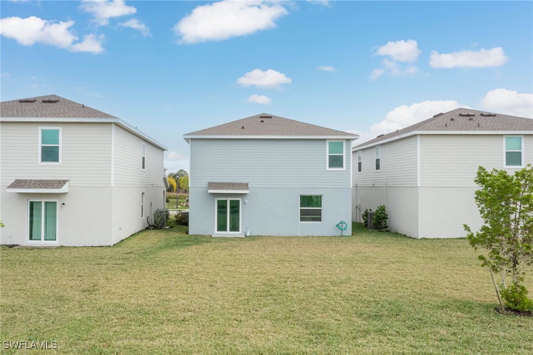 12310 Dakota Ridge Place Lehigh Acres, FL 33974 - Photo 31 of 34 a view of a house with a yard
