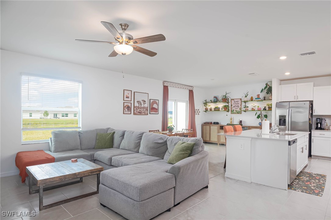 12310 Dakota Ridge Place Lehigh Acres, FL 33974 - Photo 4 of 34 a living room with furniture and a large window