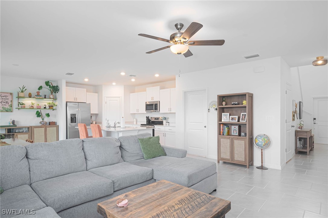 12310 Dakota Ridge Place Lehigh Acres, FL 33974 - Photo 5 of 34 a living room with furniture and kitchen view
