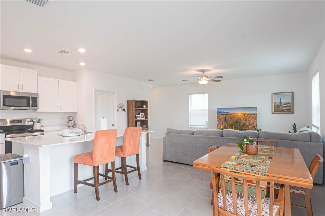 12310 Dakota Ridge Place Lehigh Acres, FL 33974 - Photo 10 of 34 a view of a dining room with furniture