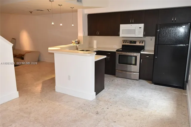 a kitchen with a sink cabinets and stainless steel appliances