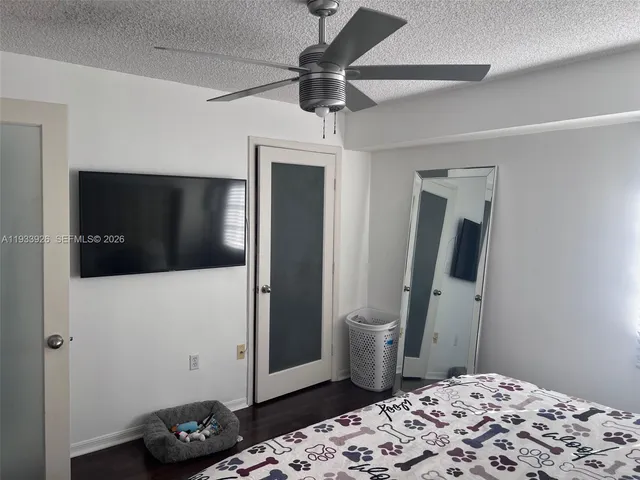a bedroom with a bed and a television