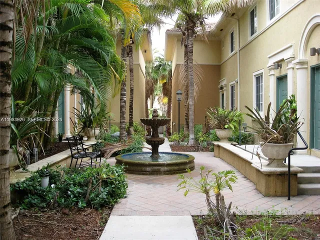 a view of a swimming pool with potted plants
