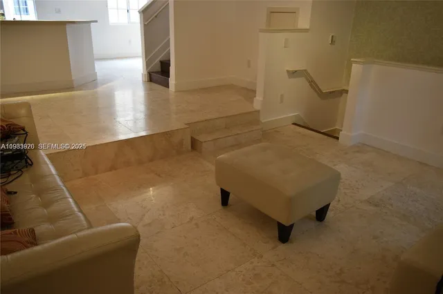 a living room with furniture and a rug