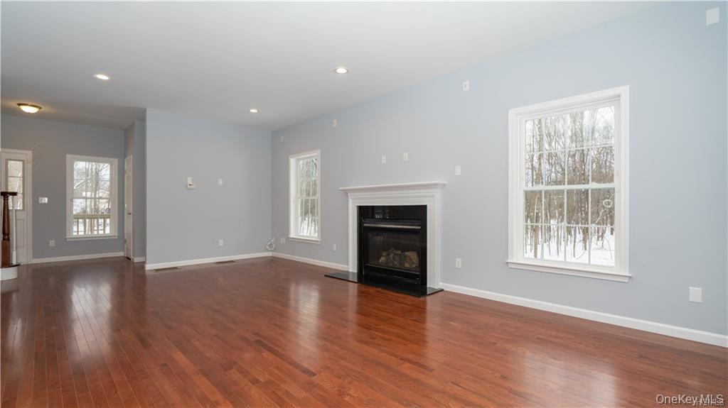 5 Harrier Ridge Drive Wallkill, NY 12589 - Photo 8 of 33 Unfurnished living room with a glass covered fireplace, recessed lighting, and dark wood finished floors