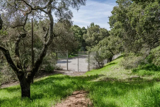 a kitchen with stainless steel appliances kitchen island granite countertop a table chairs in it and a window