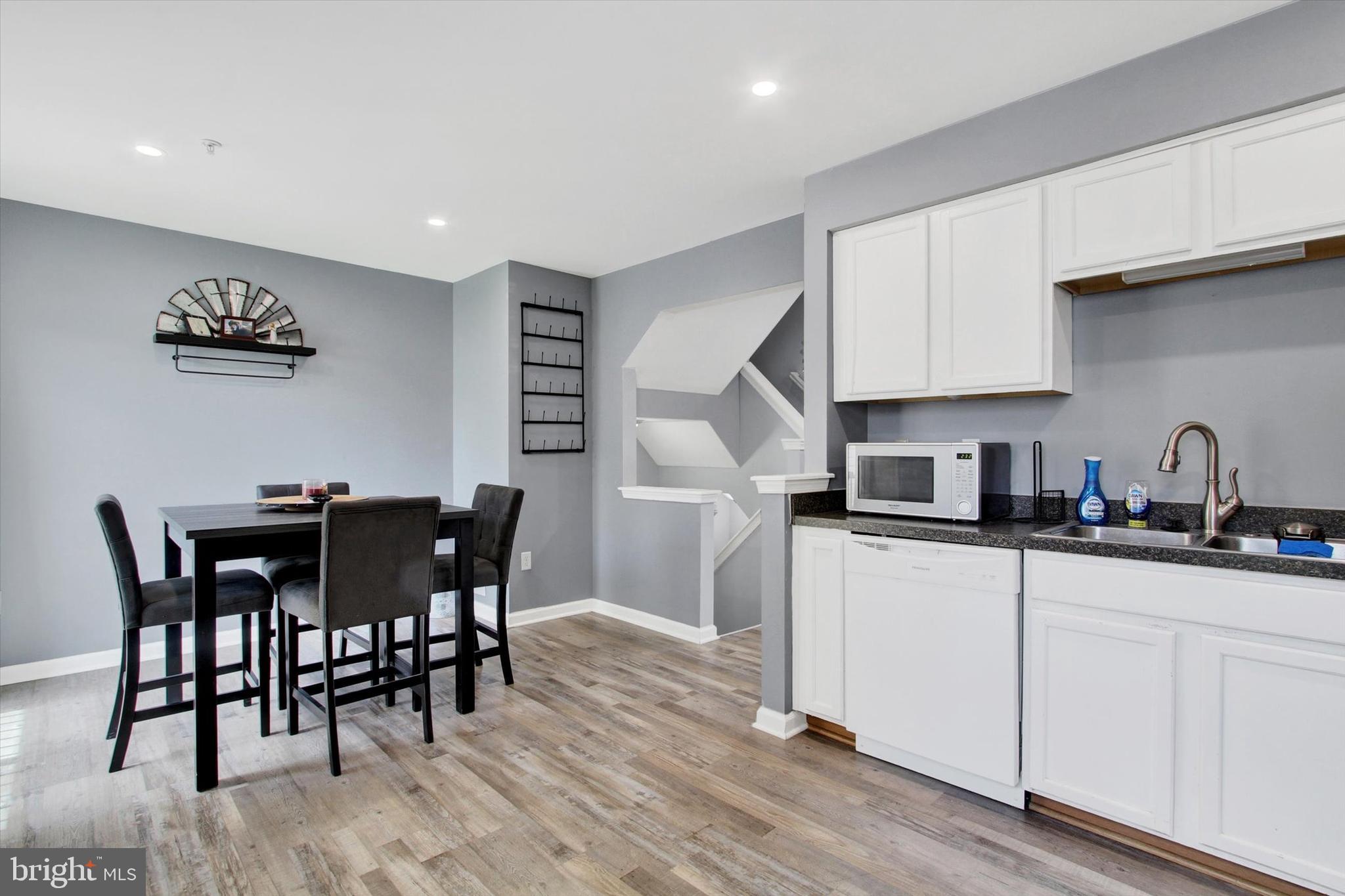 703 Grant Drive Hanover, PA 17331 - Photo 14 of 27 a kitchen with stainless steel appliances granite countertop a white cabinets and wooden floor