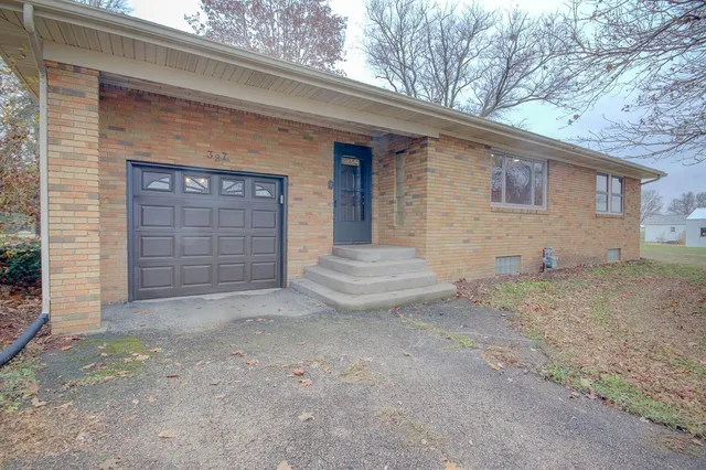 a view of a house with a yard and garage