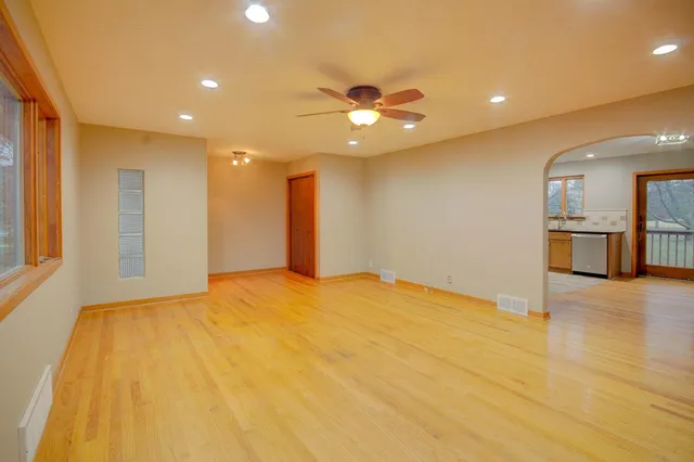 a large kitchen with stainless steel appliances granite countertop a refrigerator and a sink