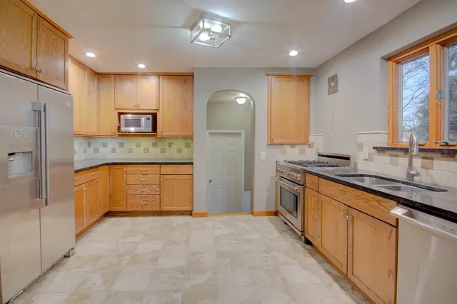 a view of a kitchen with a sink and a refrigerator