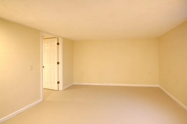 a view of an empty room with wooden walls