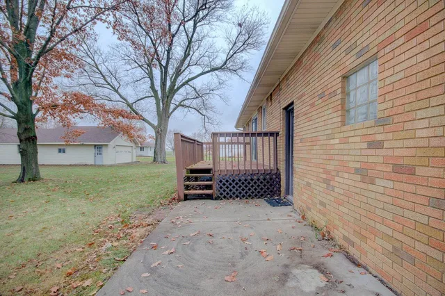 a view of a yard with wooden fence and a large tree