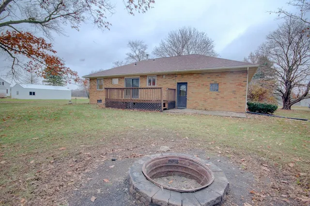a view of a field with large trees